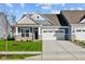 Two-story Craftsman home with gray siding, stone accents, and a two-car garage at 10618 Maidenhair Dr, Indianapolis, IN 46239