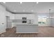 Modern kitchen with white cabinets, an island, and stainless steel appliances at 10618 Maidenhair Dr, Indianapolis, IN 46239