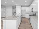 Modern kitchen with white cabinets, quartz countertops, and stainless steel appliances at 10618 Maidenhair Dr, Indianapolis, IN 46239