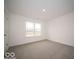 Well-lit bedroom featuring a large window and carpet at 1537 Hanover St, Danville, IN 46122