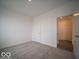 Simple bedroom with carpet, doors to hallway and another room at 1537 Hanover St, Danville, IN 46122