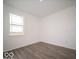 Simple bedroom with wood-look floors and a window at 1537 Hanover St, Danville, IN 46122