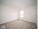 Bright bedroom with neutral carpeting and large window at 1537 Hanover St, Danville, IN 46122