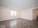 Large living room with wood-look floors and a window at 1537 Hanover St, Danville, IN 46122
