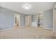 Bedroom with grey walls, carpet, built-in shelving, and bath access at 4176 N 625 W, Bargersville, IN 46106