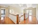 Upstairs hallway with hardwood floors and access to bedrooms at 4176 N 625 W, Bargersville, IN 46106