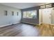 Bright living room with large window, gray walls, and wood-look floors at 1726 Trace Ln, Indianapolis, IN 46260