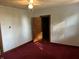 Simple bedroom with red carpet, ceiling fan and closet at 353 S Washington St, Clinton, IN 47842