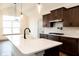 Modern kitchen with dark cabinets, white quartz countertops, and gas range at 3657 Sycamore Bend S Way, Columbus, IN 47203