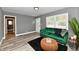 Spacious living room with a comfy green couch and modern decor at 2035 N Tibbs Ave, Indianapolis, IN 46222