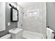 Updated bathroom with marble-look tile and a new tub at 2035 N Tibbs Ave, Indianapolis, IN 46222
