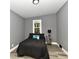 Bright bedroom with a queen bed and night stand at 2035 N Tibbs Ave, Indianapolis, IN 46222