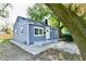 Charming gray house with a well-manicured lawn and mature trees at 2035 N Tibbs Ave, Indianapolis, IN 46222