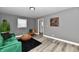Bright living room with a green sofa, stylish decor, and wood-look floors at 2035 N Tibbs Ave, Indianapolis, IN 46222