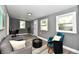Open living room with gray couch and teal accent chair at 2035 N Tibbs Ave, Indianapolis, IN 46222