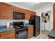 Kitchen boasts black appliances and wood cabinets at 6517 Emerald Hill Ct # Apt 312, Indianapolis, IN 46237