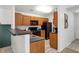 Modern kitchen with dark wood cabinets and black appliances at 6517 Emerald Hill Ct # Apt 312, Indianapolis, IN 46237