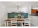 Charming dining room with a rustic table and green accent wall at 6517 Emerald Hill Ct # Apt 312, Indianapolis, IN 46237