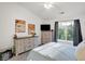 Bright bedroom with large window, dresser, and comfortable bed at 6517 Emerald Hill Ct # Apt 312, Indianapolis, IN 46237
