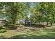 Two-story home nestled in a wooded area with manicured lawn at 8954 Briarclift Rd, Indianapolis, IN 46256
