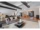 Open concept living room with hardwood floors, exposed beams, and fireplace at 8954 Briarclift Rd, Indianapolis, IN 46256