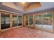 Sunroom with brick floor, sliding doors, and ceiling fan at 8954 Briarclift Rd, Indianapolis, IN 46256