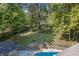 Large backyard with stone retaining wall and trees at 8954 Briarclift Rd, Indianapolis, IN 46256