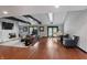 Spacious living room with hardwood floors, stone fireplace, and large windows at 8954 Briarclift Rd, Indianapolis, IN 46256