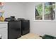 Laundry room with modern washer and dryer, and window at 8954 Briarclift Rd, Indianapolis, IN 46256