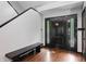 Entryway with hardwood floors, black door, and bench at 8954 Briarclift Rd, Indianapolis, IN 46256