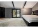 Main bedroom with plush bed, patio access, and grey walls at 8954 Briarclift Rd, Indianapolis, IN 46256