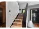 Modern staircase with dark wood accents and carpeted steps at 8954 Briarclift Rd, Indianapolis, IN 46256