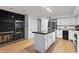 Updated kitchen features white cabinets, a large island, and a stone fireplace at 8954 Briarclift Rd, Indianapolis, IN 46256