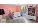 bedroom with pink walls, bookshelf, and window at 8954 Briarclift Rd, Indianapolis, IN 46256