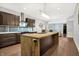 Open concept kitchen with island, dark cabinetry, and stainless steel appliances at 6129 Crittenden Ave, Indianapolis, IN 46220