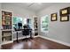 Home office with built-in shelves, hardwood floors, and a large window at 6129 Crittenden Ave, Indianapolis, IN 46220