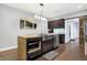 Modern kitchen with large island, stainless steel appliances, and wood flooring at 6129 Crittenden Ave, Indianapolis, IN 46220