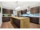 Modern kitchen with an island, dark cabinetry, and stainless steel appliances at 6129 Crittenden Ave, Indianapolis, IN 46220