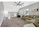 Large loft with a ceiling fan, exercise bike and comfortable sectional sofa at 6129 Crittenden Ave, Indianapolis, IN 46220