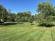 Landscaped lawn with lush green grass and mature trees at 1230 Thorndon Ct, Danville, IN 46122