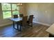 Bright dining room featuring a rustic wood table with four brown chairs and a large window at 1230 Thorndon Ct, Danville, IN 46122