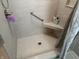 Clean shower with light gray tile, built-in seat, and grab bar at 1230 Thorndon Ct, Danville, IN 46122