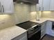 Kitchen with white cabinets, granite countertops, and brick backsplash at 1230 Thorndon Ct, Danville, IN 46122