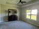 Large bedroom with carpeted floors, ceiling fan, dresser and a view of the backyard at 1230 Thorndon Ct, Danville, IN 46122