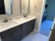 Bathroom with double vanity, dark brown cabinets, and a view of bedroom at 1230 Thorndon Ct, Danville, IN 46122