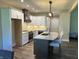 Modern kitchen with white shaker cabinets, granite countertops, and a large island at 1230 Thorndon Ct, Danville, IN 46122