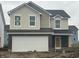 Two-story home with beige vinyl siding, white garage door, and dark roof at 11011 Walter Dr, Indianapolis, IN 46235