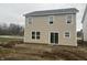 Tan vinyl-sided two-story house with sliding glass door and unfinished yard at 11011 Walter Dr, Indianapolis, IN 46235