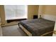 Bedroom with queen bed, window seat, and wall-mounted Murphy bed at 5347 Waterton Lakes Dr, Indianapolis, IN 46237