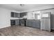 Modern kitchen with gray cabinets, granite counters, and appliances at 1526 Lawton Ave, Indianapolis, IN 46203